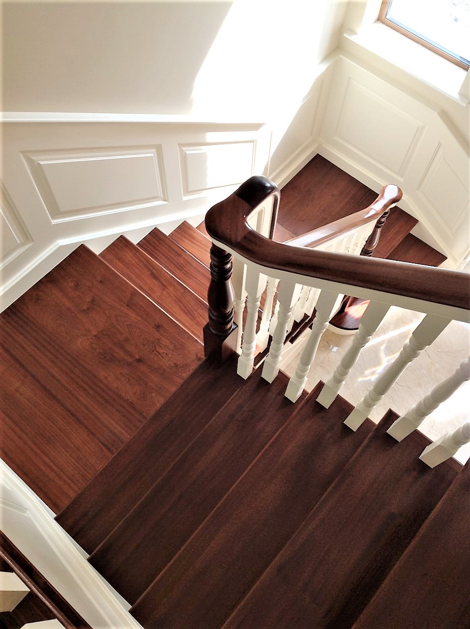 Mahogany and ivory cut string stairs with continuous handrail and wall ...